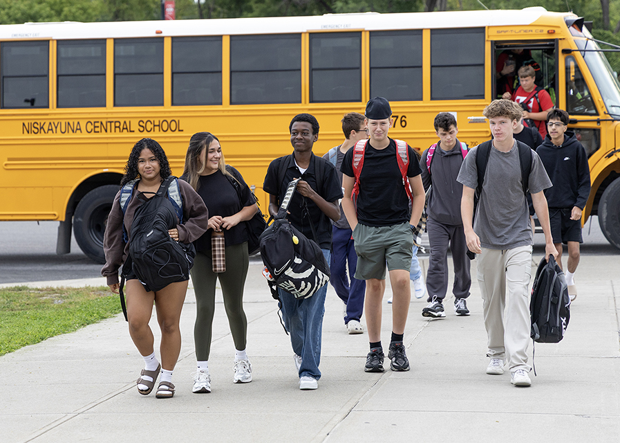 High school students exiting the bus at school.