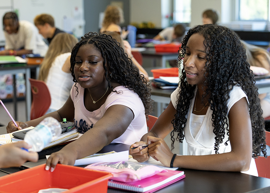 Two students preparing for a project in a classroom.