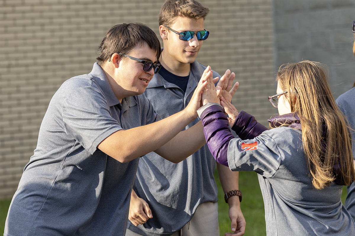 unified bocce players high five