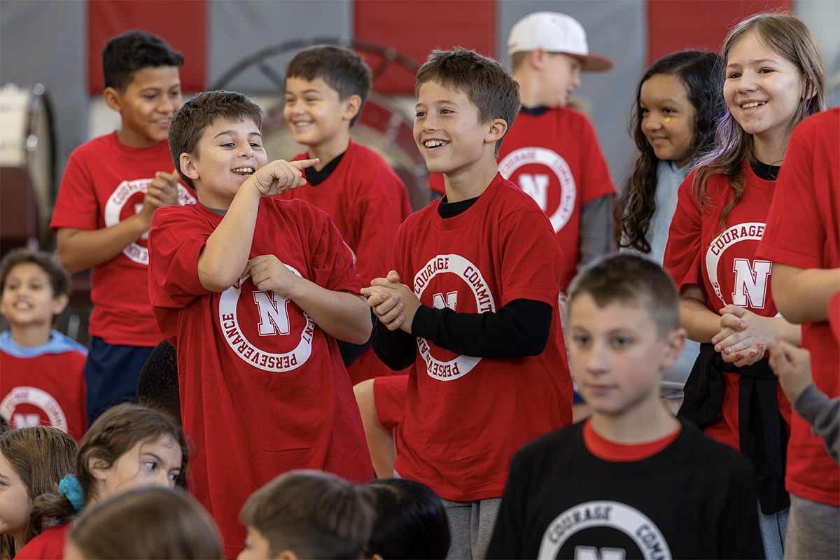 group of middle school students laughing together in gym