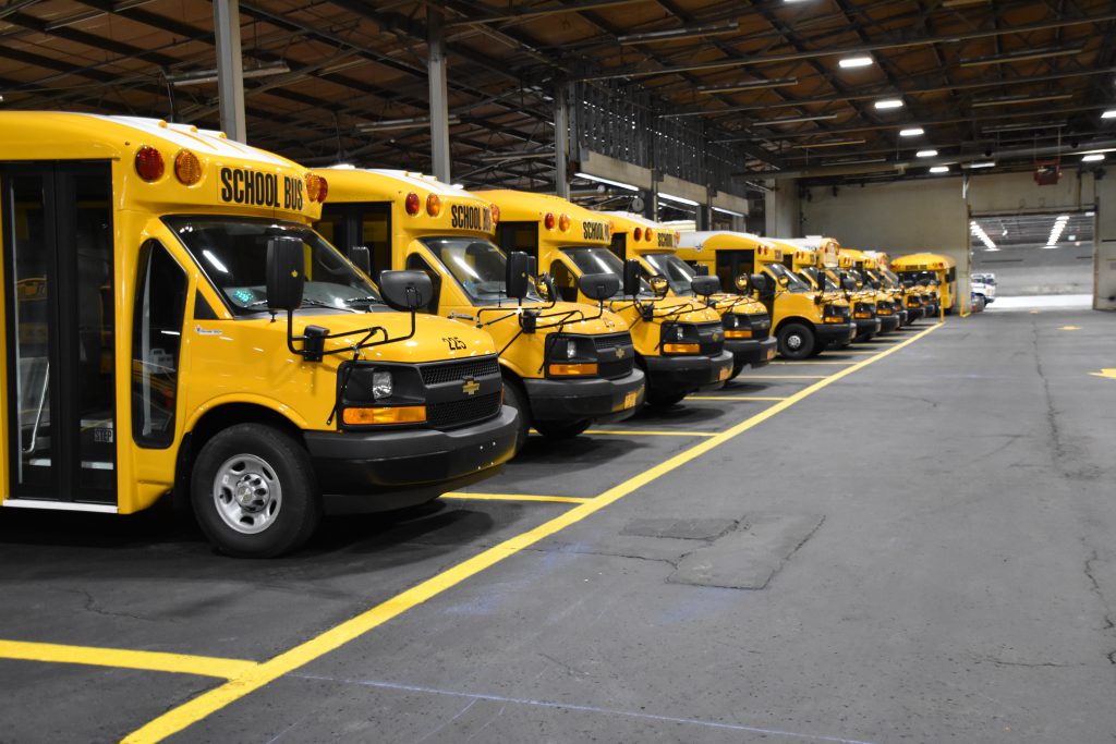 Busses lined up in a row in garage