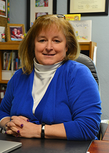 Photo of Birchwood Principal Deb Berndt at her desk in her office