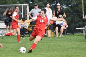 a Niskayuna High School girls soccer player kicking the ball