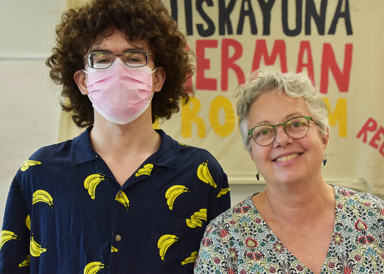student wearing mask with teacher
