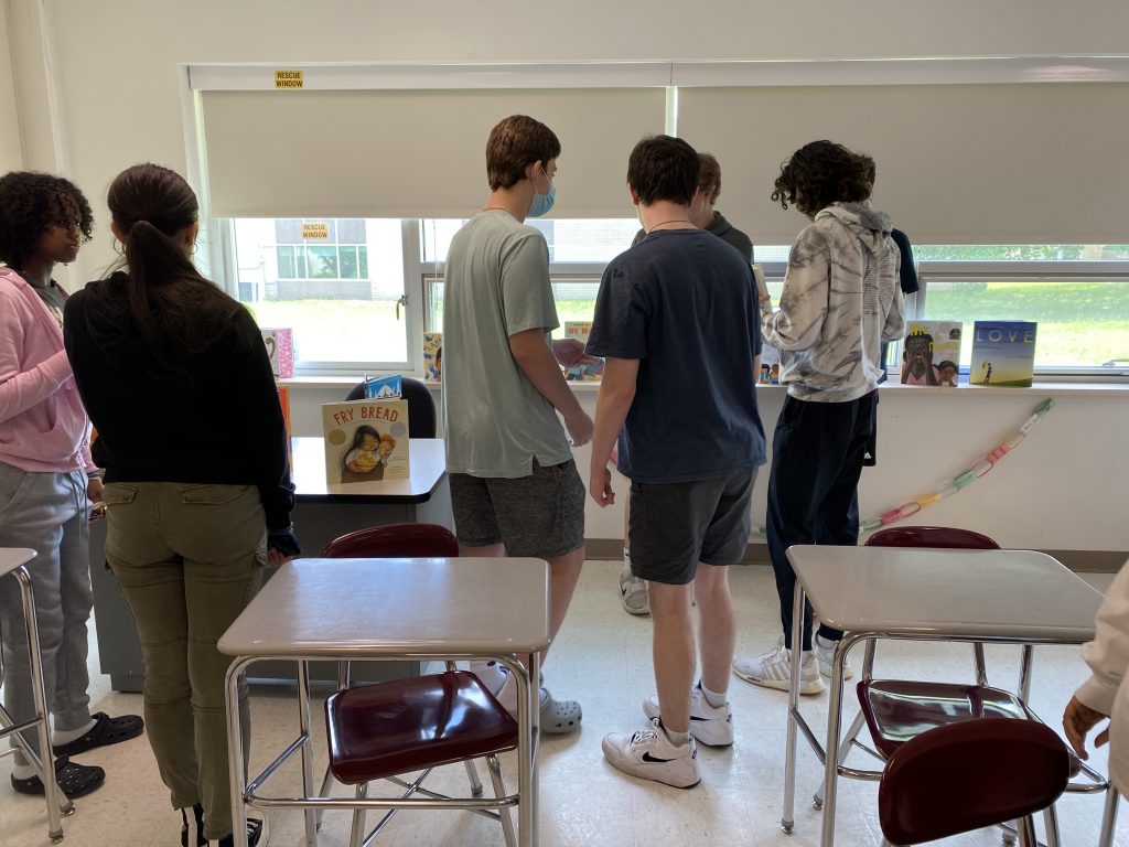 10th grade students selecting books for the little free libraries