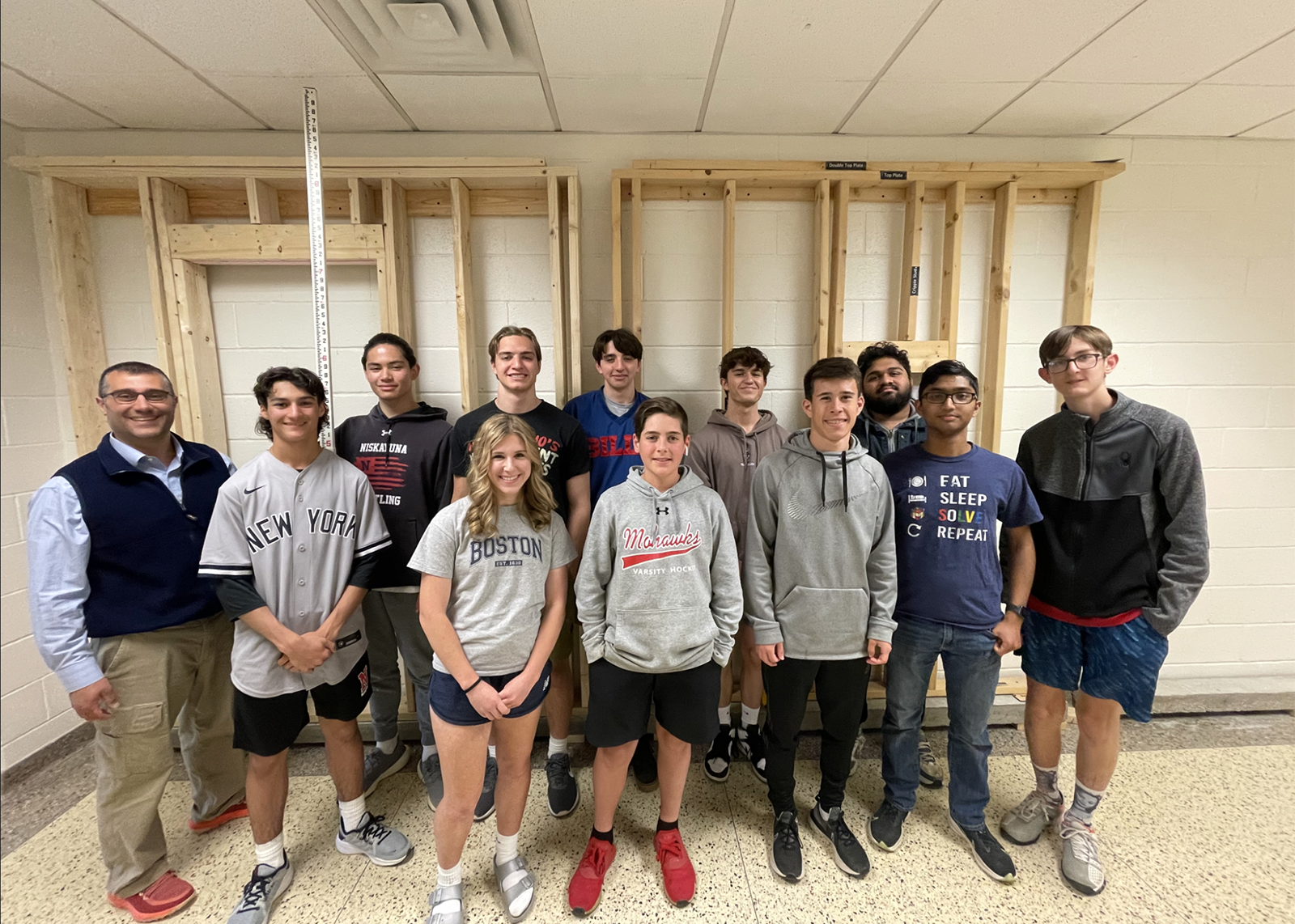 group of students smiling at camera with teacher