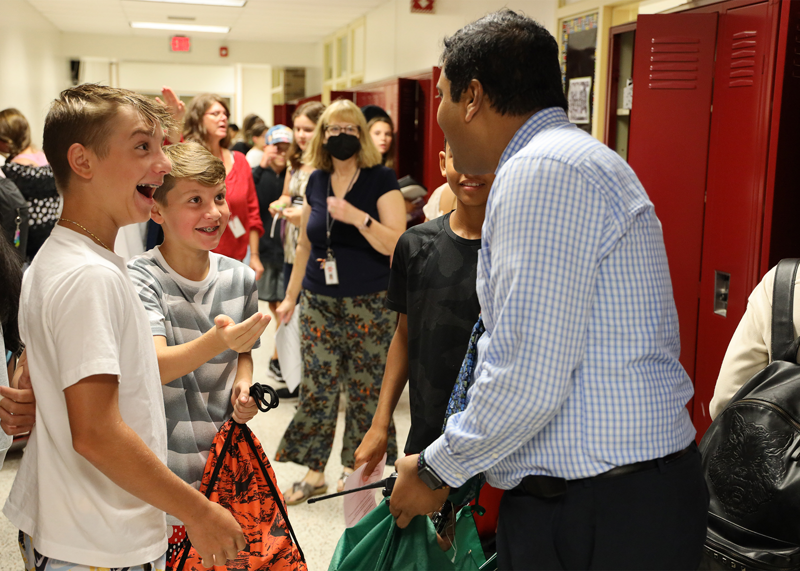 students excited to see teacher in hallway