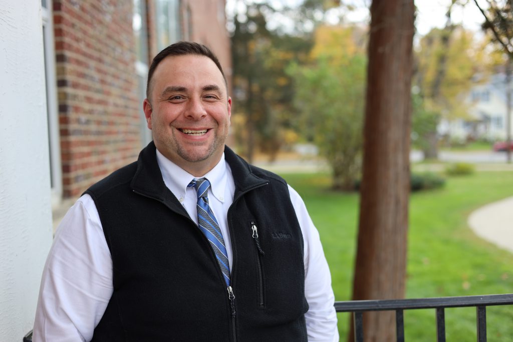 New Iroquois principal outside smiling at camera