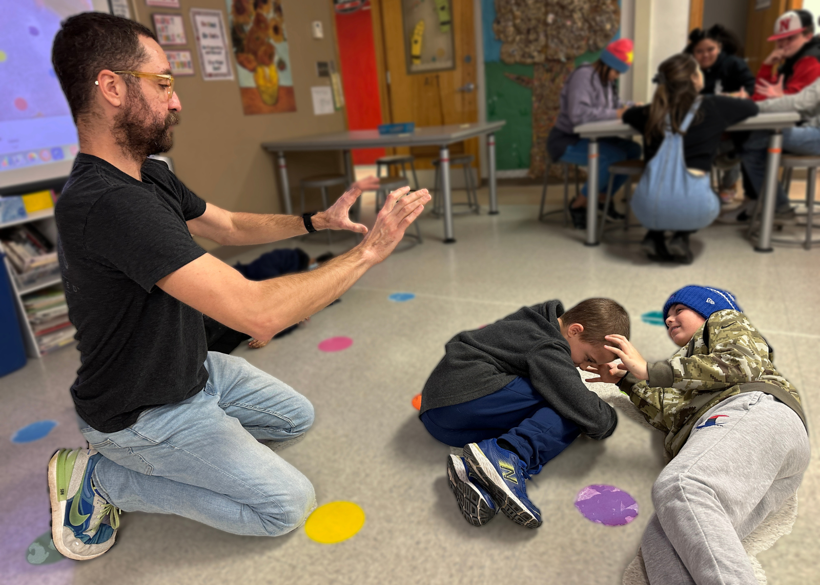 Artist with to student laying on floor