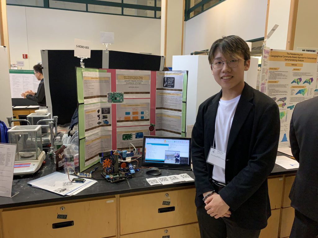 Arthur Leung standing with his project