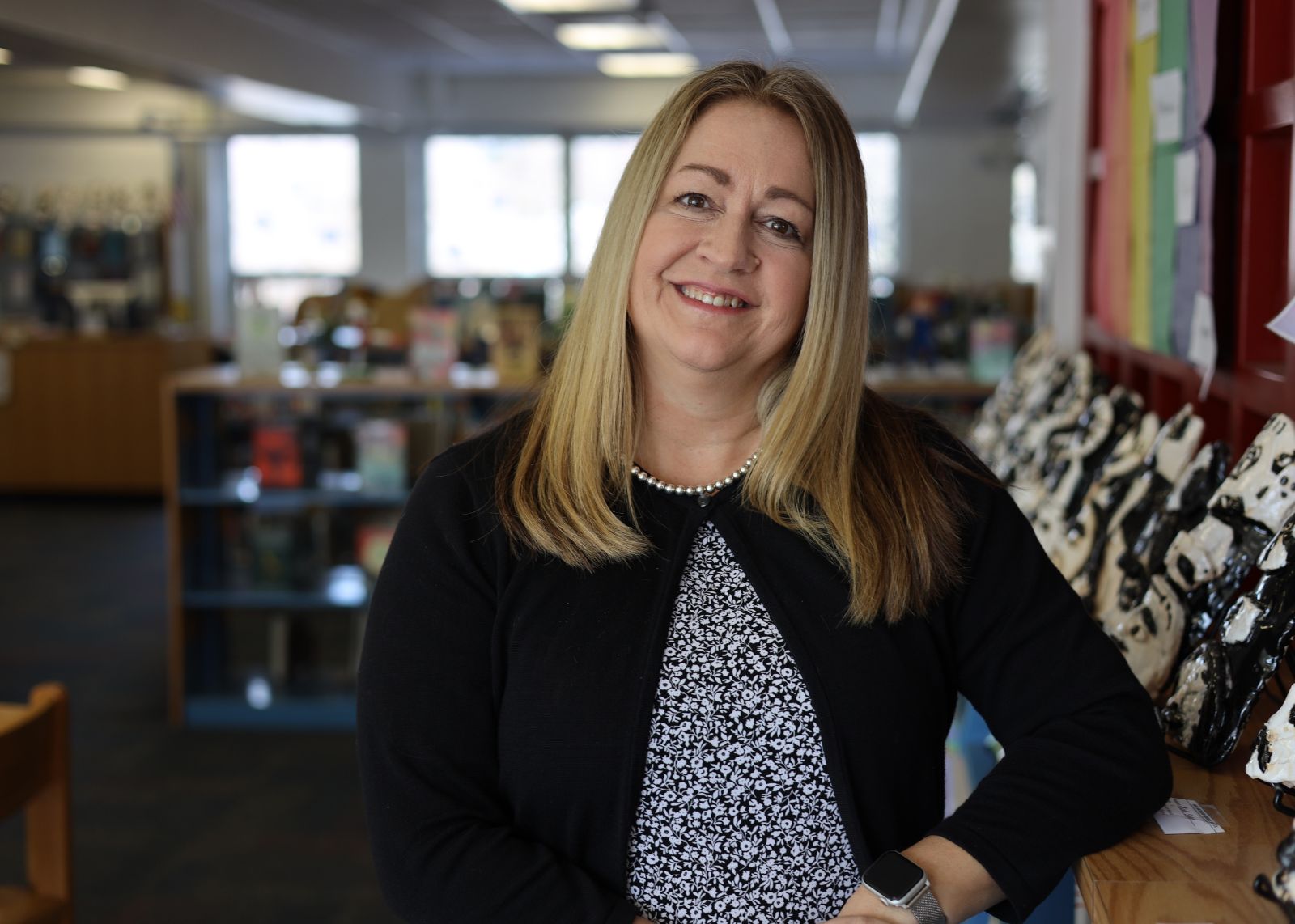 Teacher smiles in library