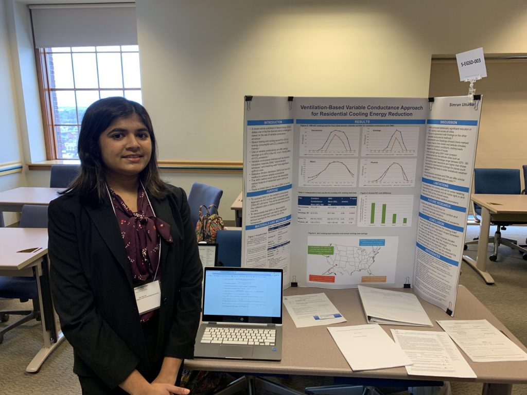 Simran Utturkar standing with her project