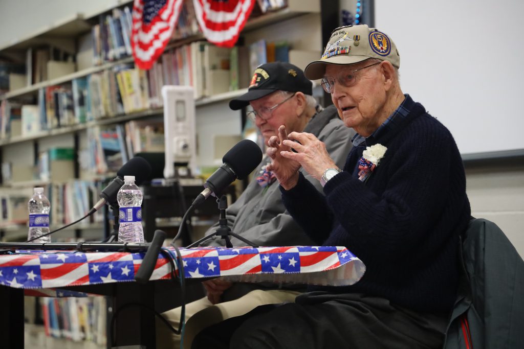 World War II veterans Charlie Levezque (left) and Bill Rochelle speak with students.