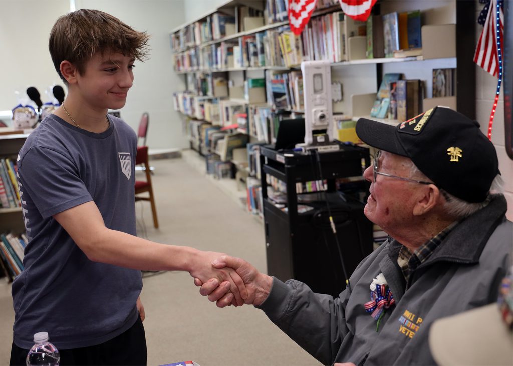 student shakes veterans hand
