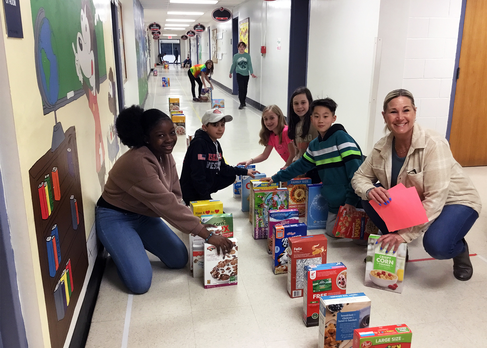 students setting up cereal box dominoes