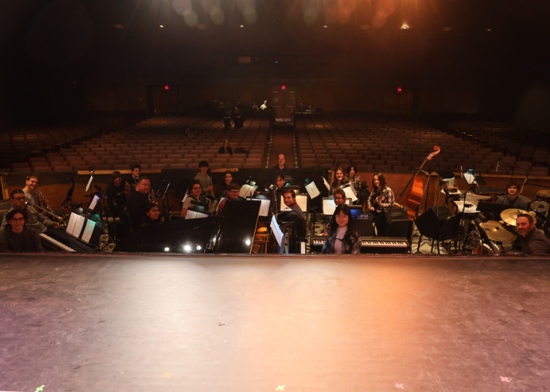 Orchestra students gathered in pit below stage