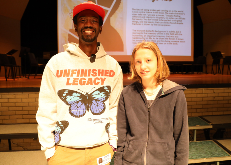 Student stands with author