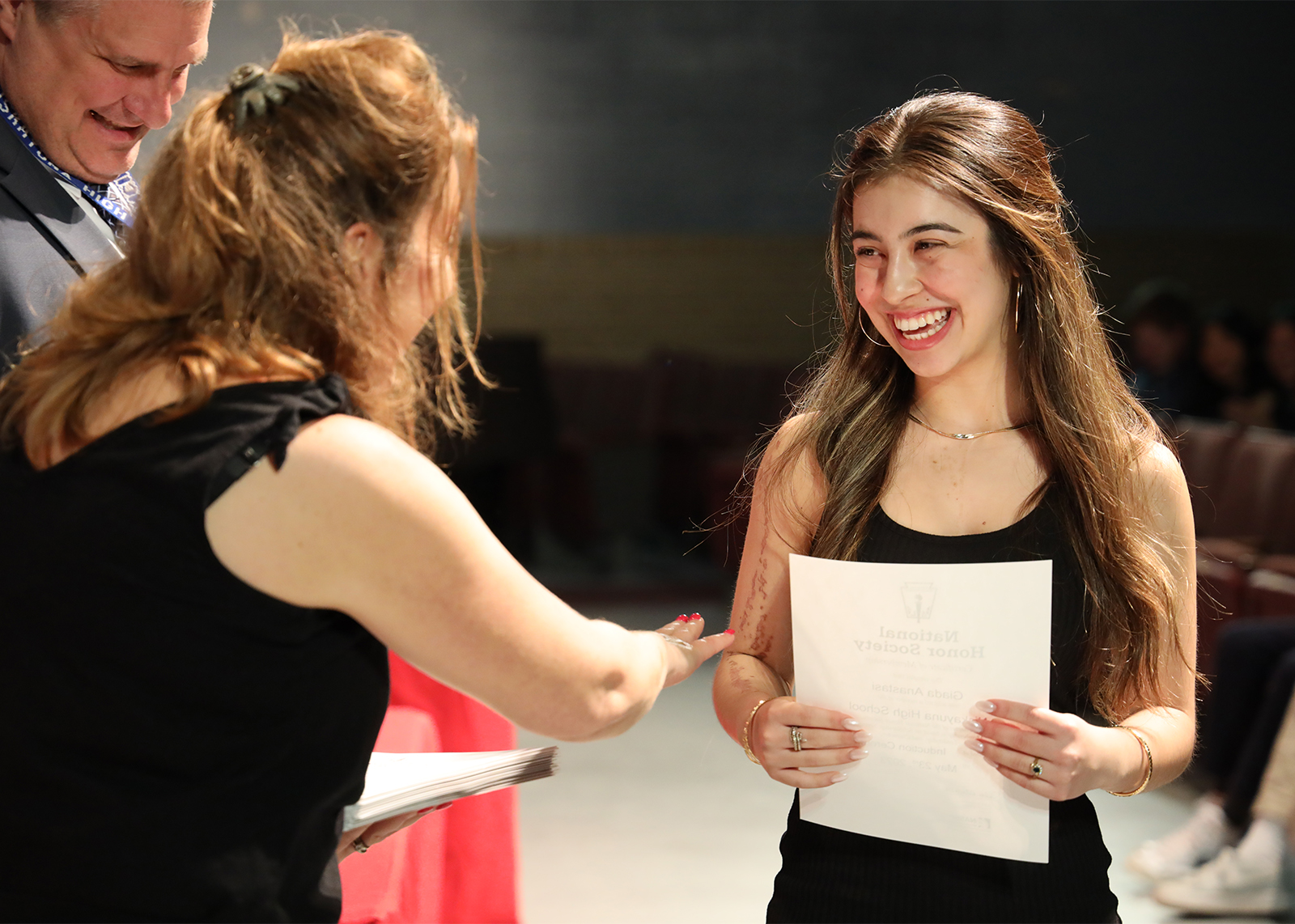 student smiling while being inducted into the national honor society