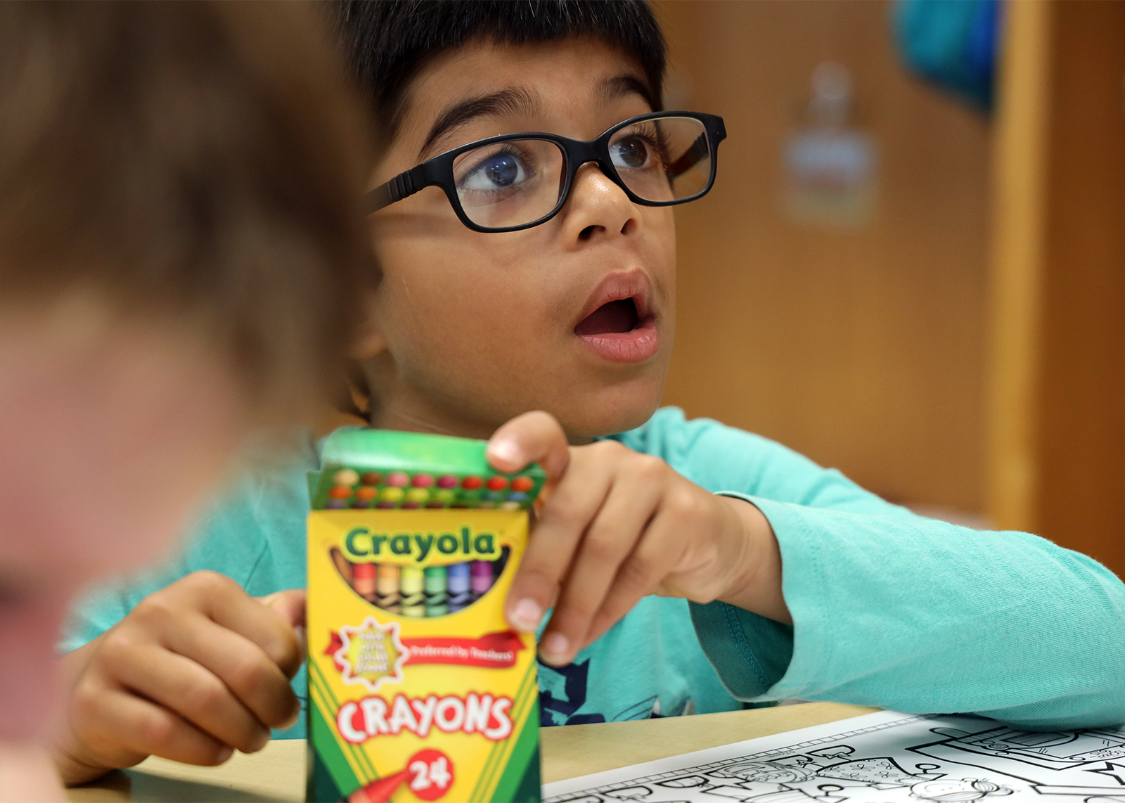 elementary student amazed with crayons