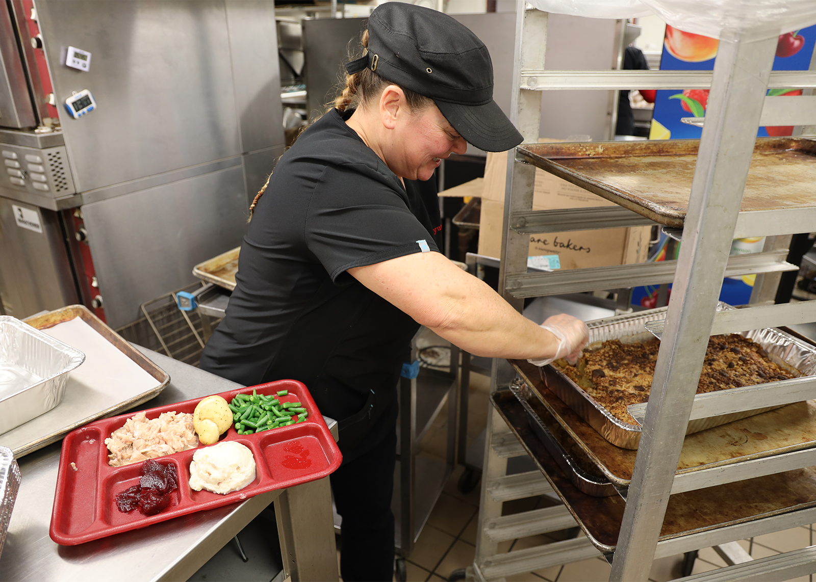 cafeteria manager plating a turkey feast