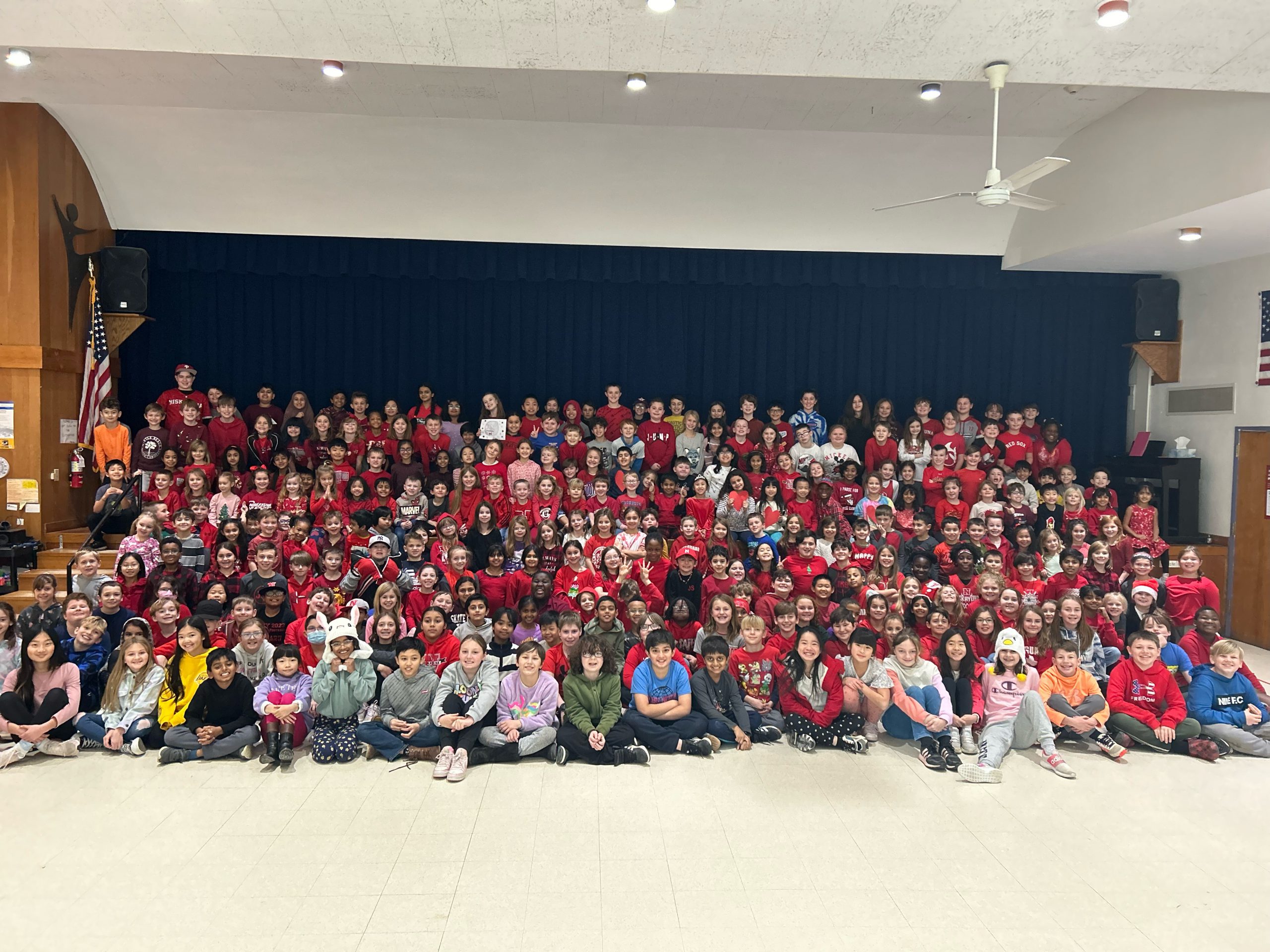 Birchwood Elementary School students wear red and gather for a photo in support of 4th grader Jack Salinetti, who is fighting leukemia.