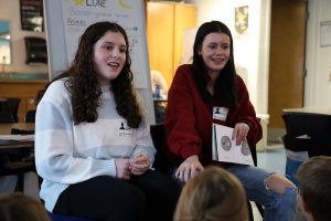 Peri Levine (left) and Alana Fulmsbee (right) read "Bonsoir Lune" (Goodnight Moon) to Mrs. McDonald's third grade class at Glencliff.