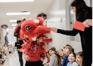 Rosendale students perform the lion dance through school hallway.