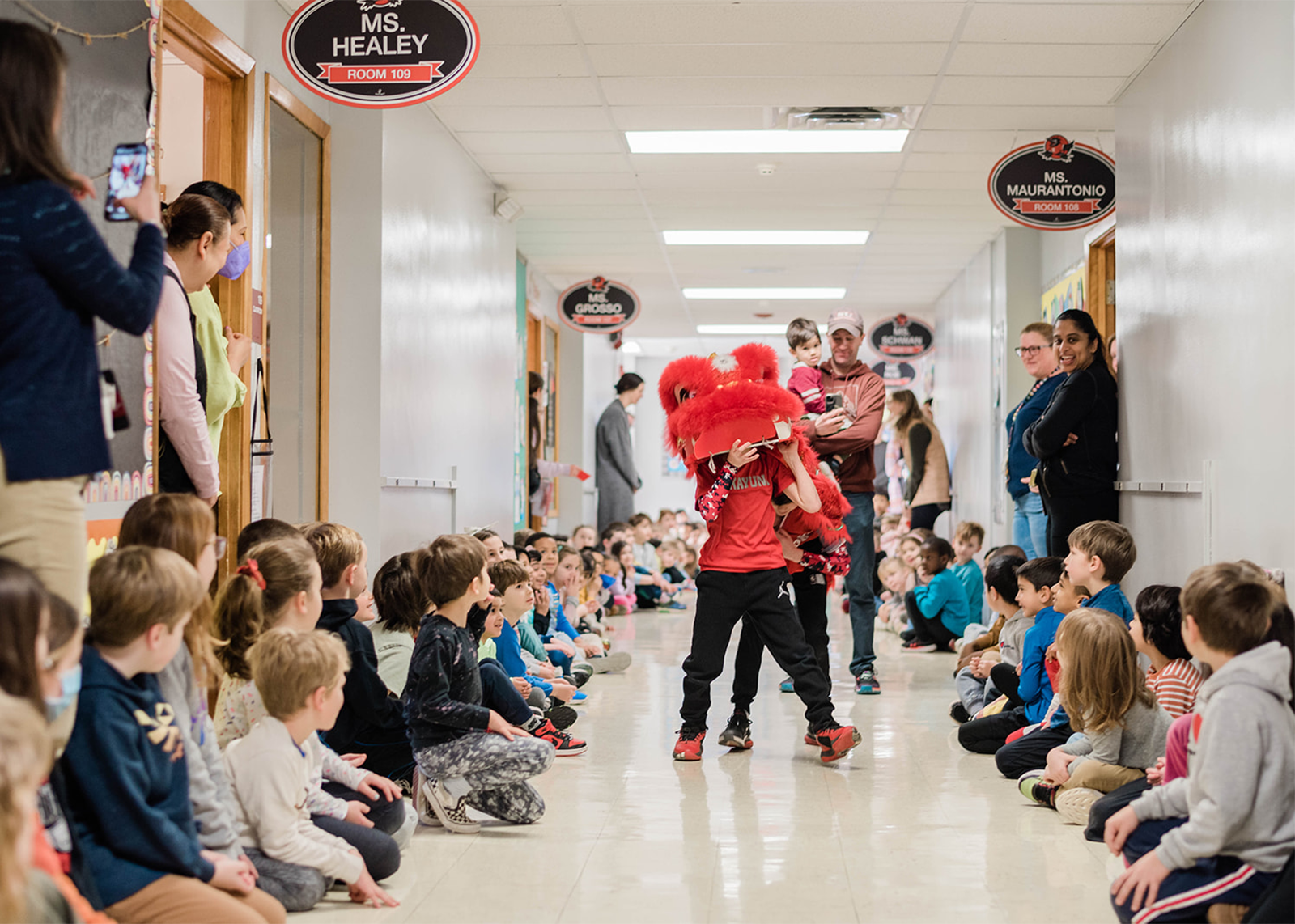 Rosendale students perform the lion dance through school hallway.