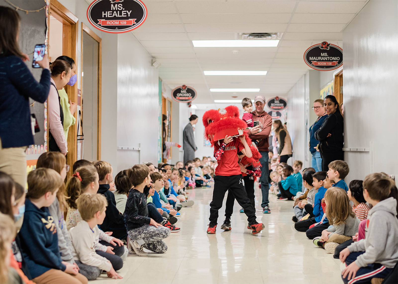 Rosendale students perform the lion dance through school hallway