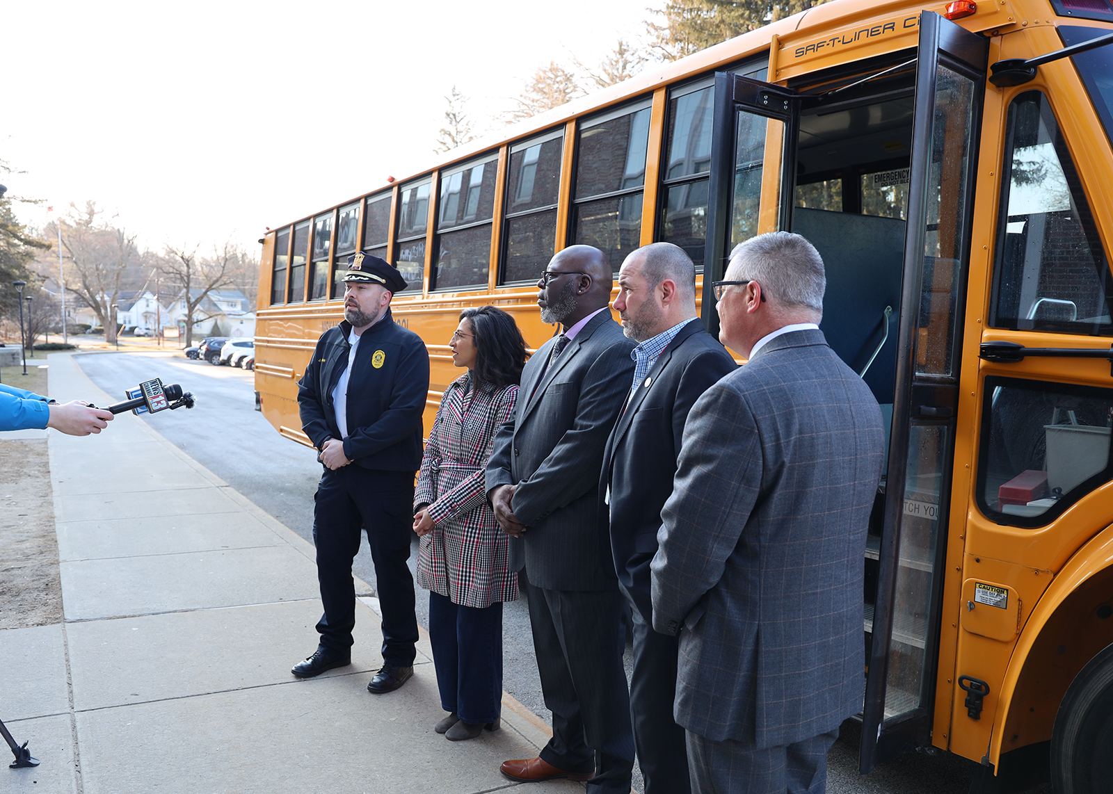 Niskayuna Police Chief Jordan Kochan, Supervisor Jaime Puccioni, NCSD Transportation Director Richard Kirk, Assistant Superintendent of Business and Operations Matt Leon and Superintendent Carl Mummenthey speak to local media about the new AI-powered stop arm cameras on all district buses.