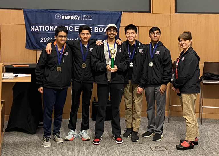 group of students smiling after science bowl win