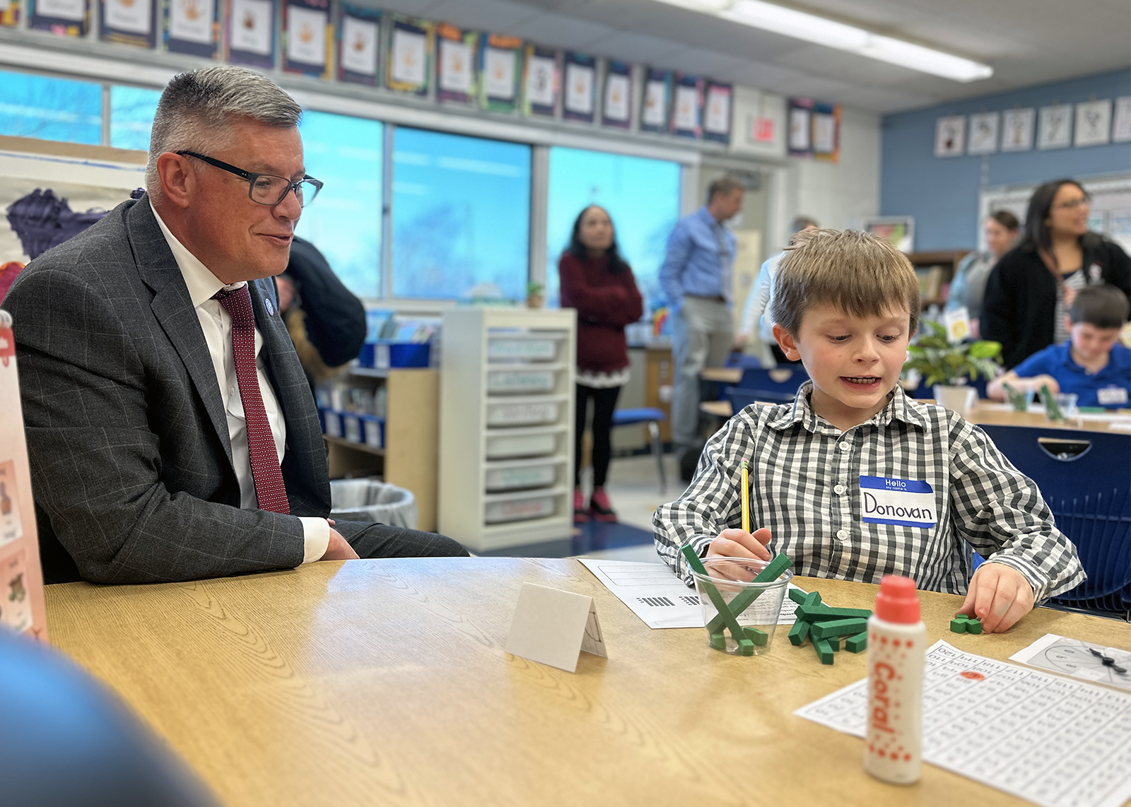 superintendent with student doing math