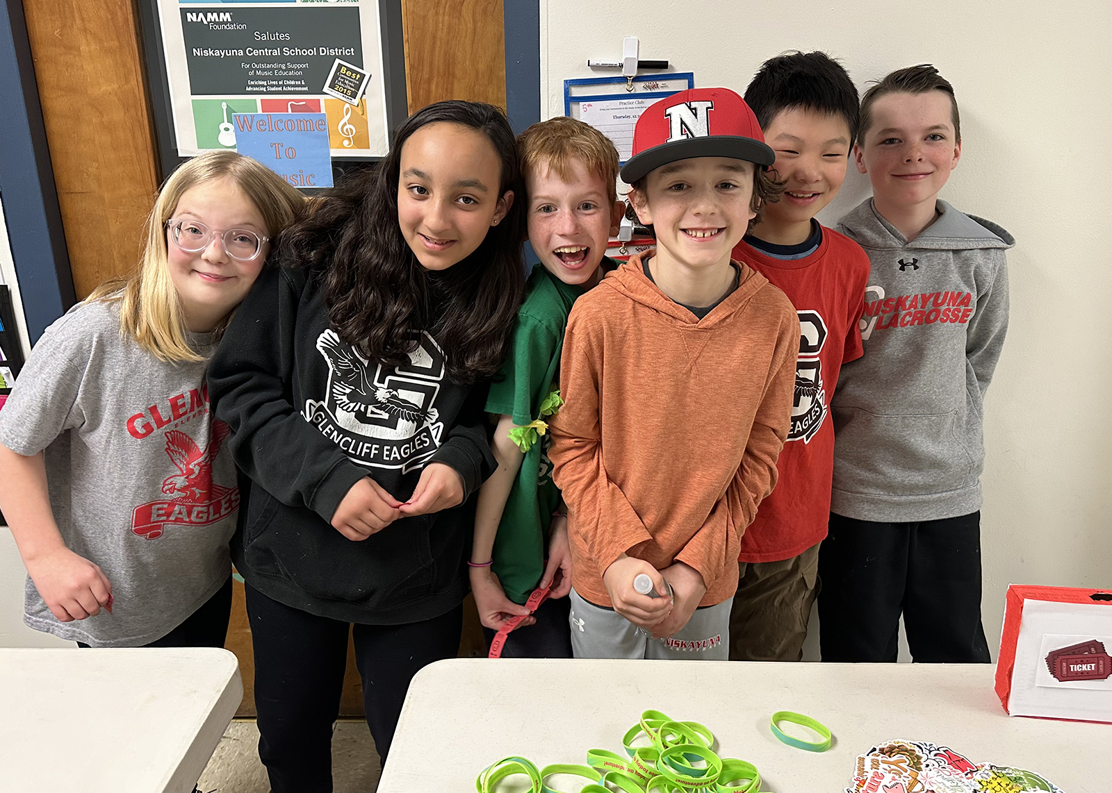 students at a concession table smiling