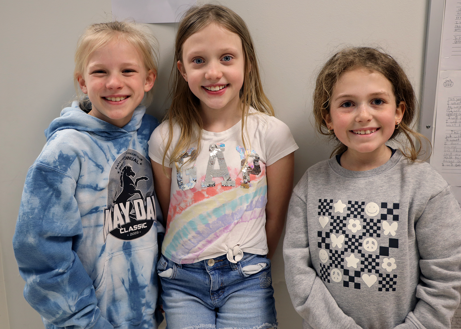 three friends smiling at camera