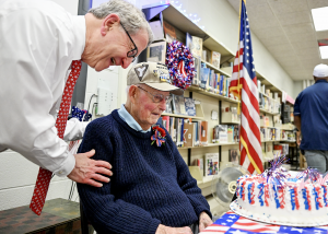 social studies teacher laughs with WWII veteran