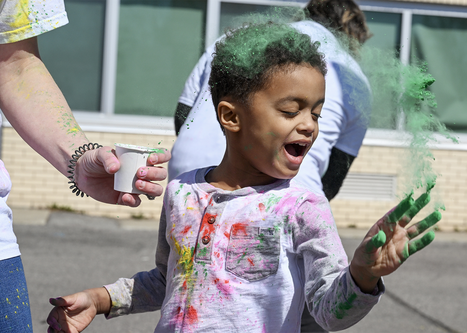 student celebrating Holi with colored powder
