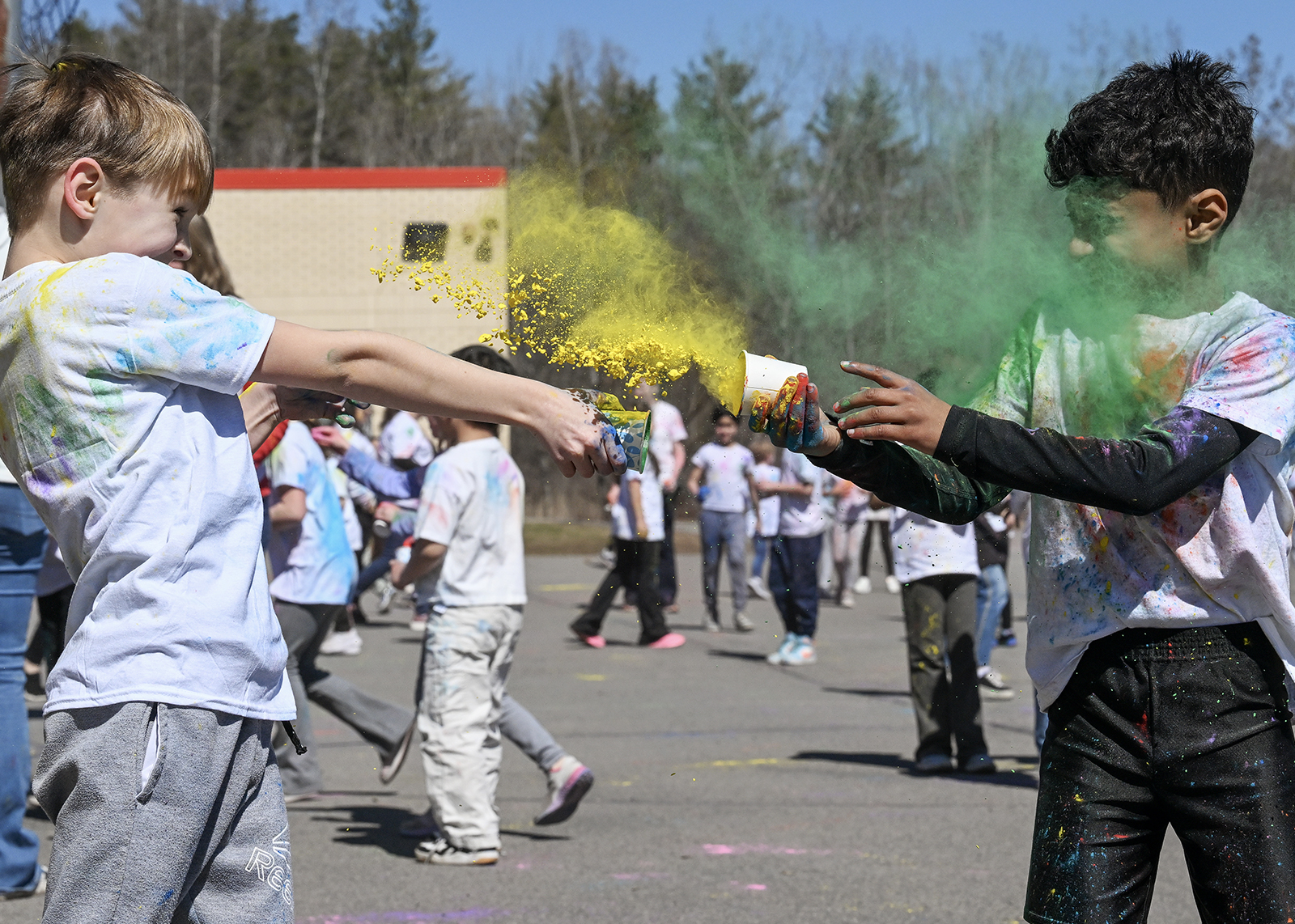 student celebrating Holi with colored powder