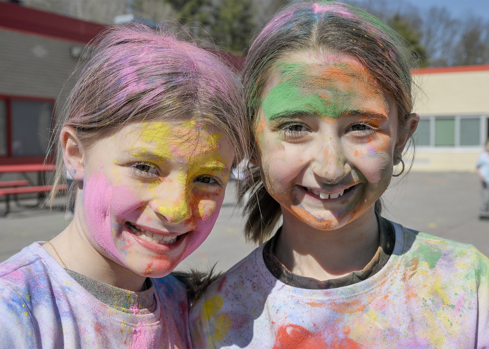 students celebrating Holi with colored powder