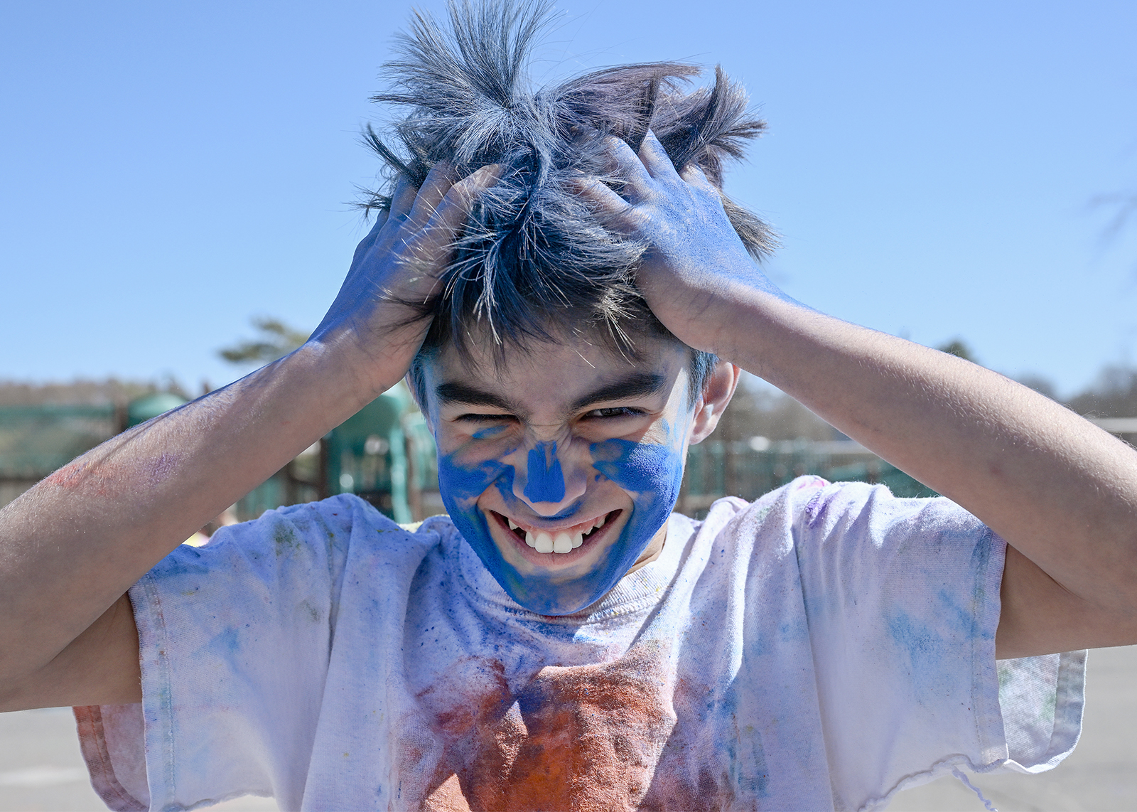 student celebrating Holi with colored powder