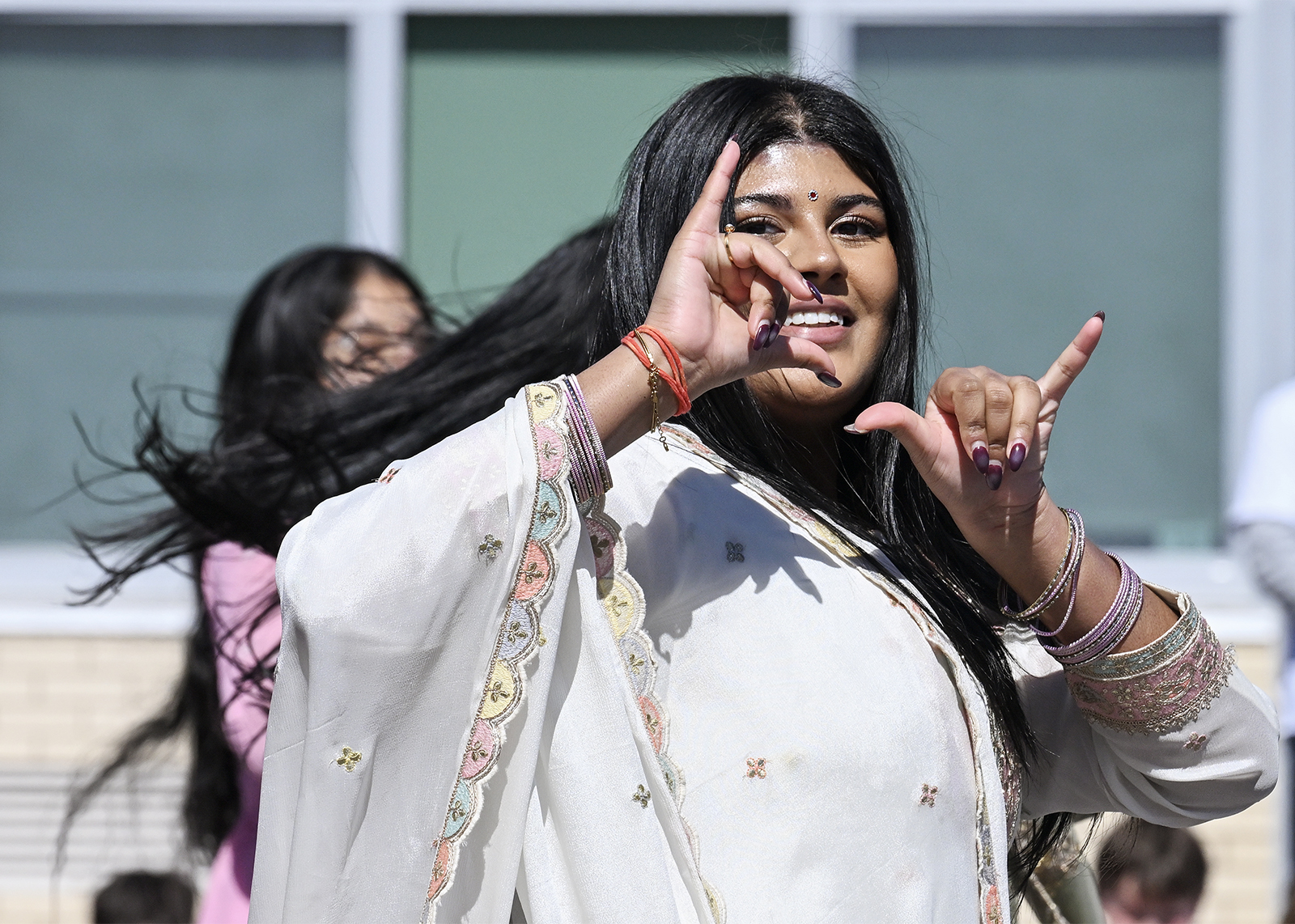 student dances at Holi celebration