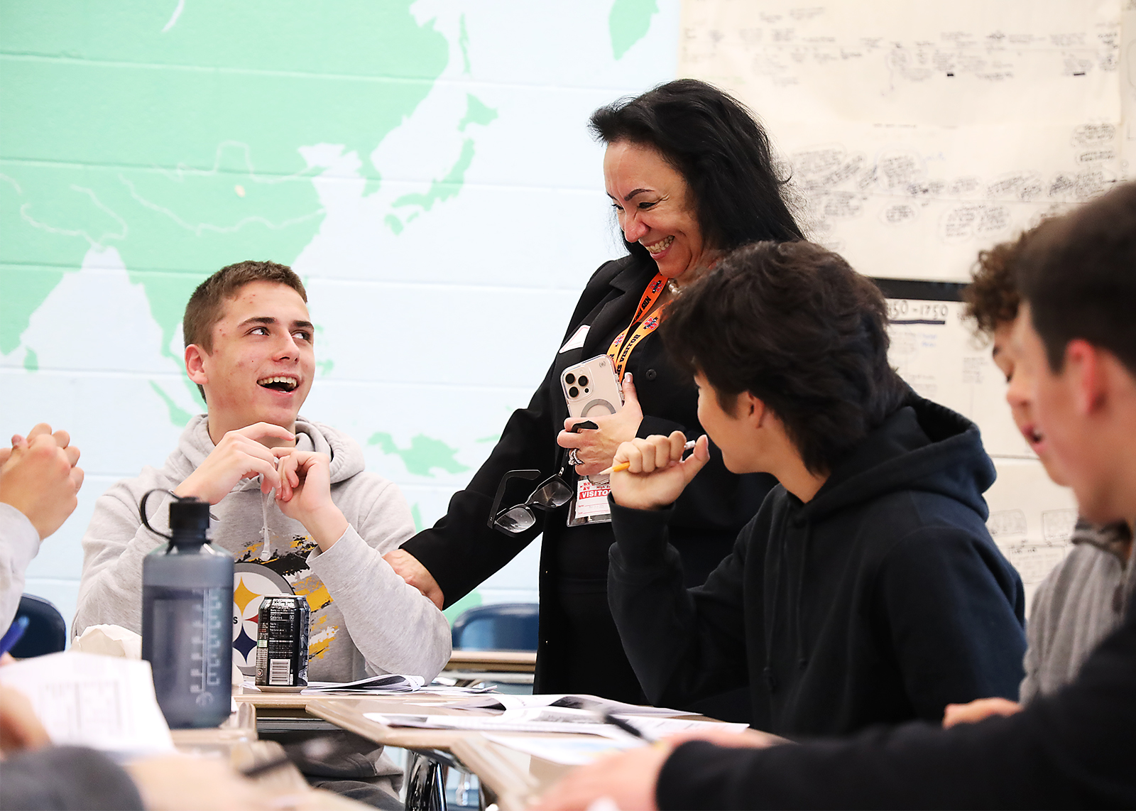 high school student laughs with commisioner of state education