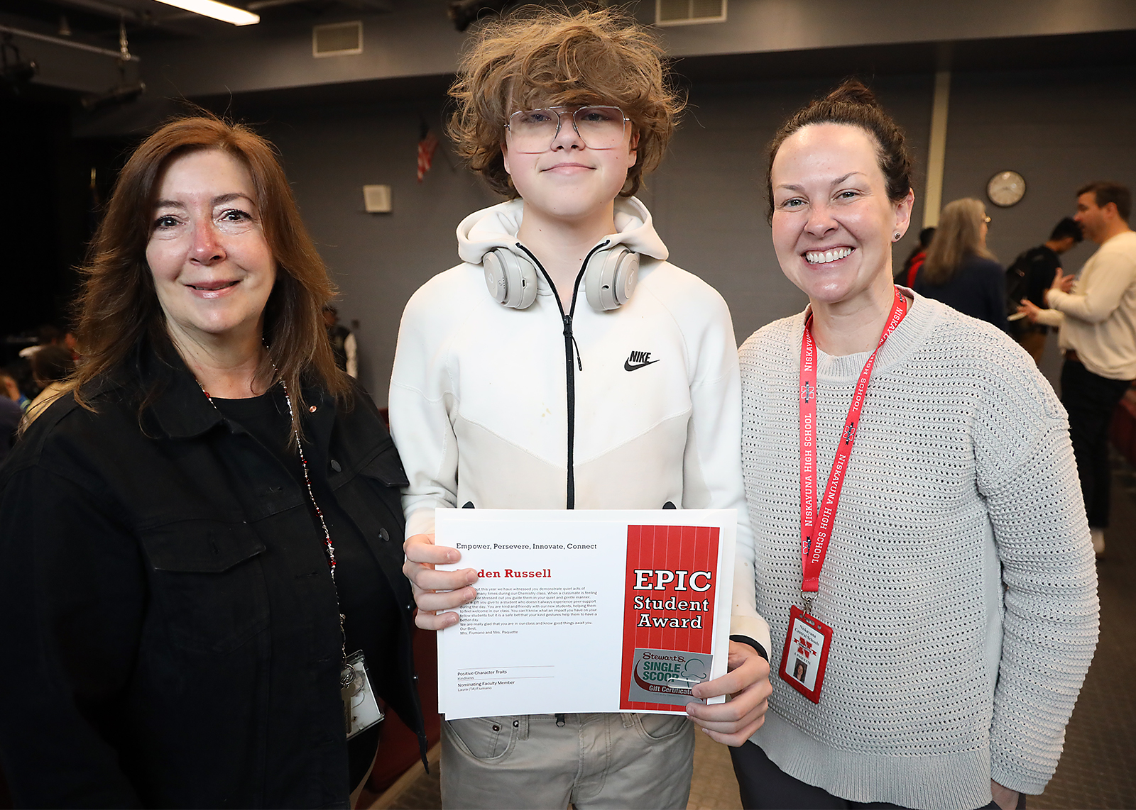 student with teachers after getting an EPIC award