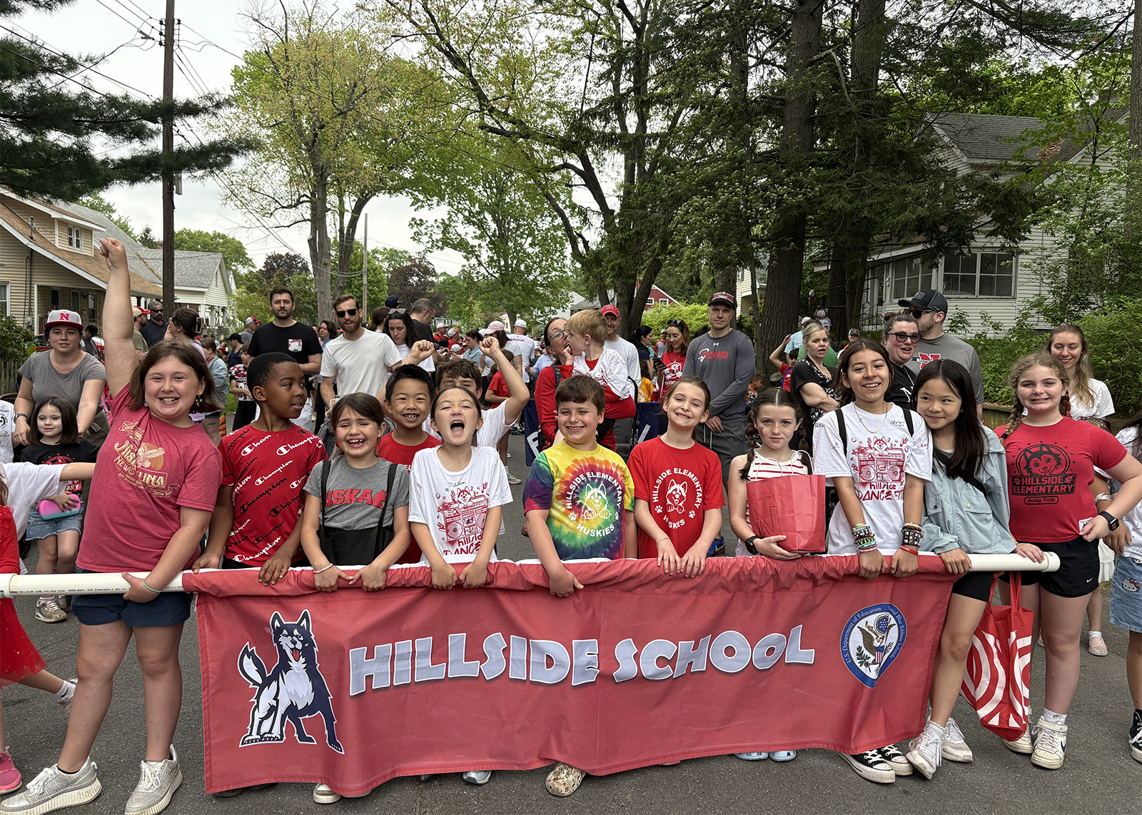 group of elementary students in front of banner that reads Hillside School