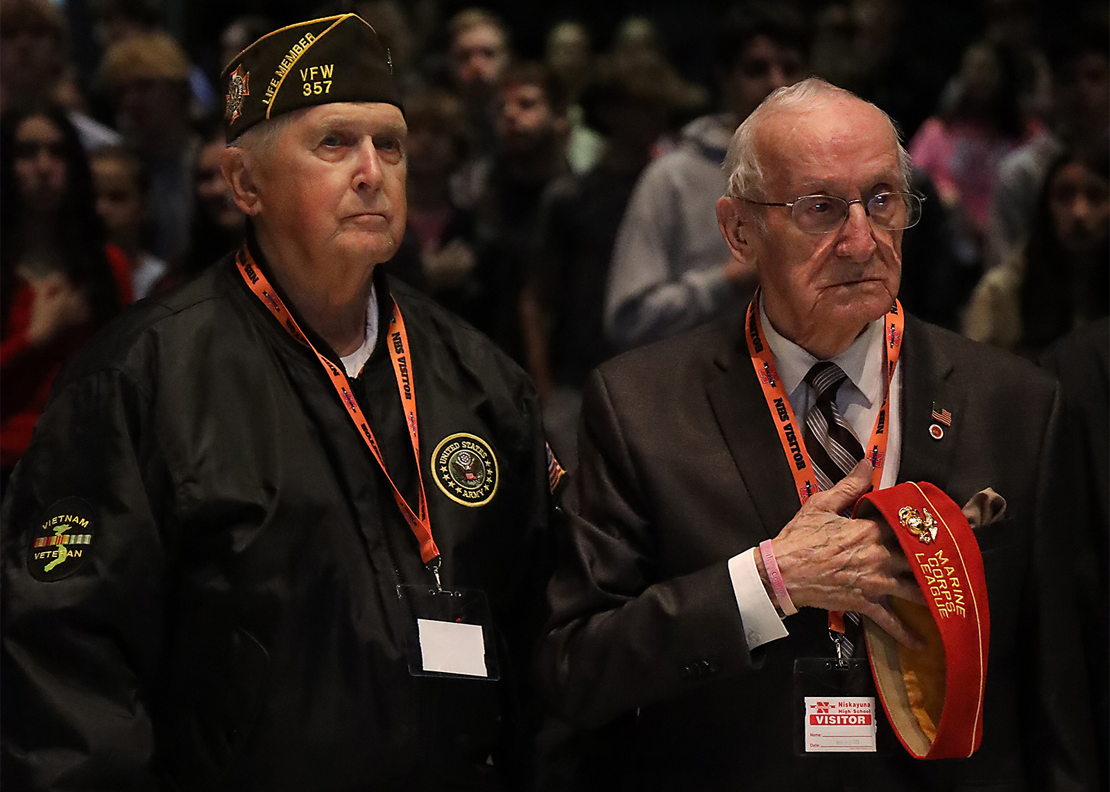 two veteran stand in the high school auditorium
