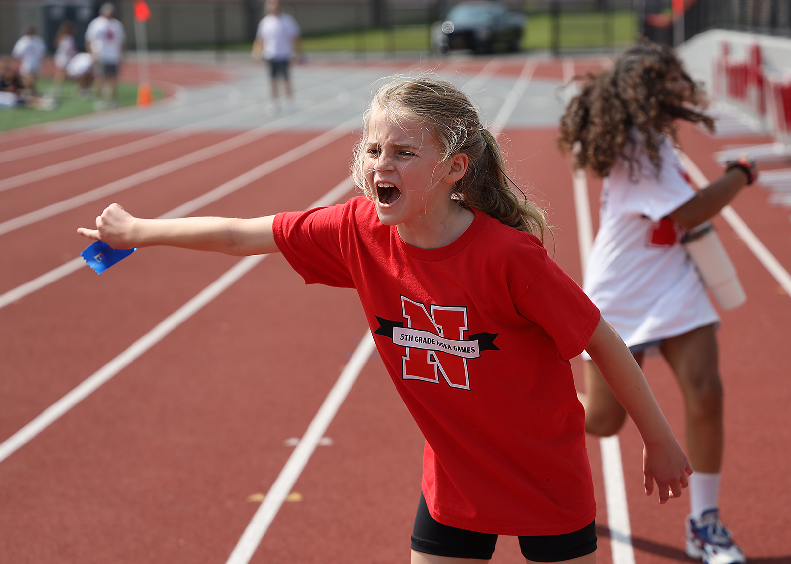 elementarry student cheering on the track