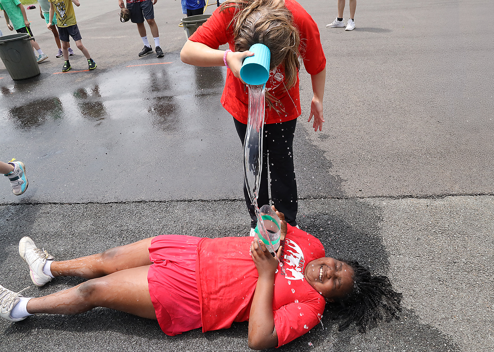 elementary students pouring water at field day