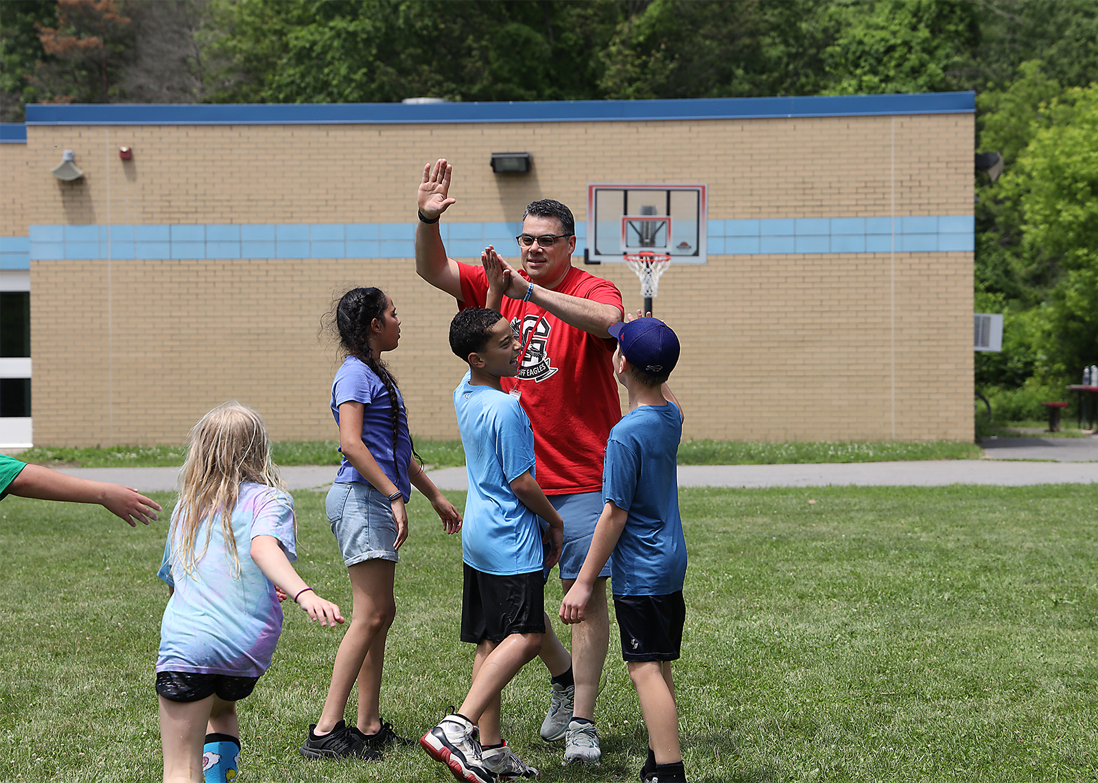 elementary students high fiving principal
