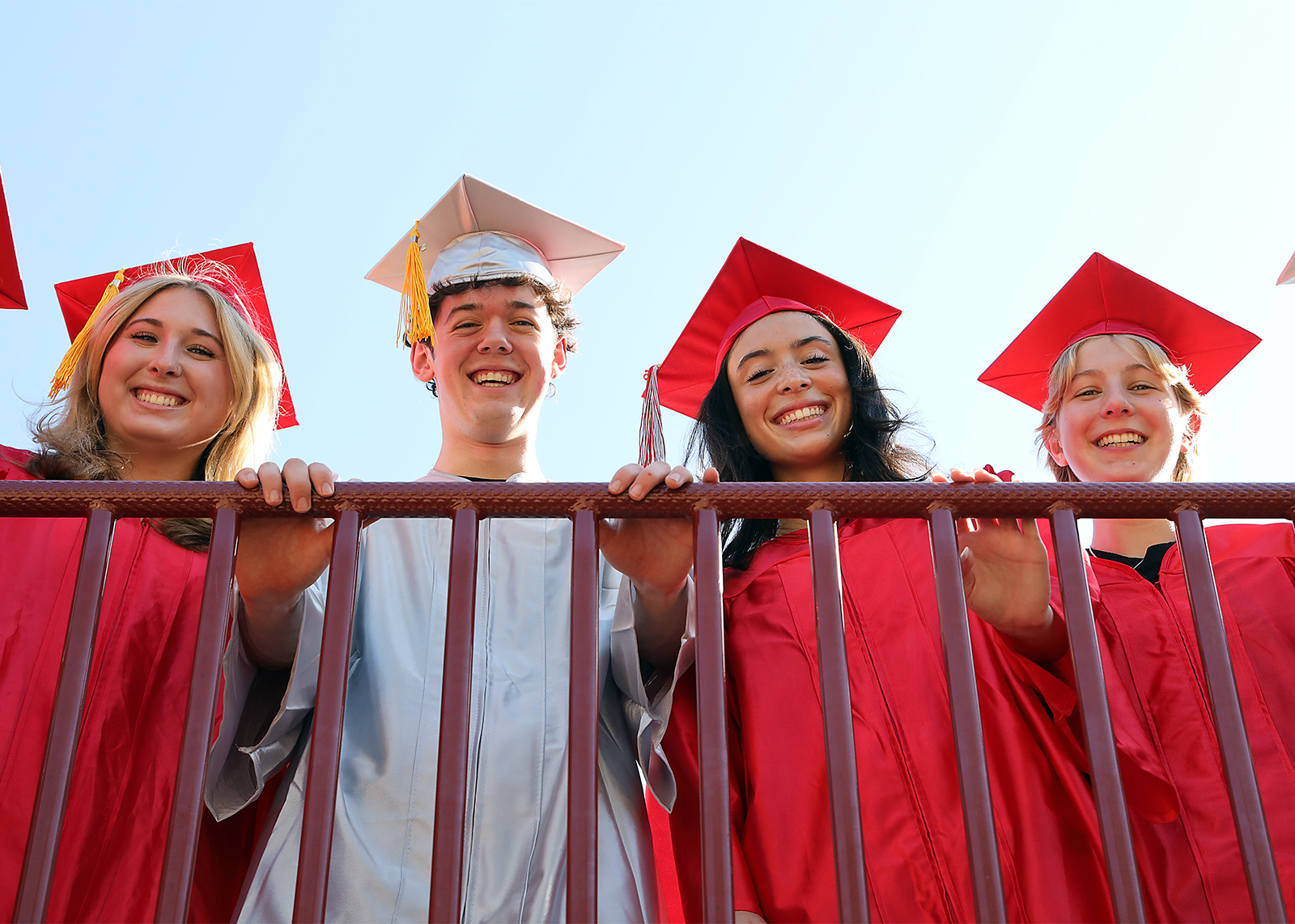 seniors looking over railing down at camera