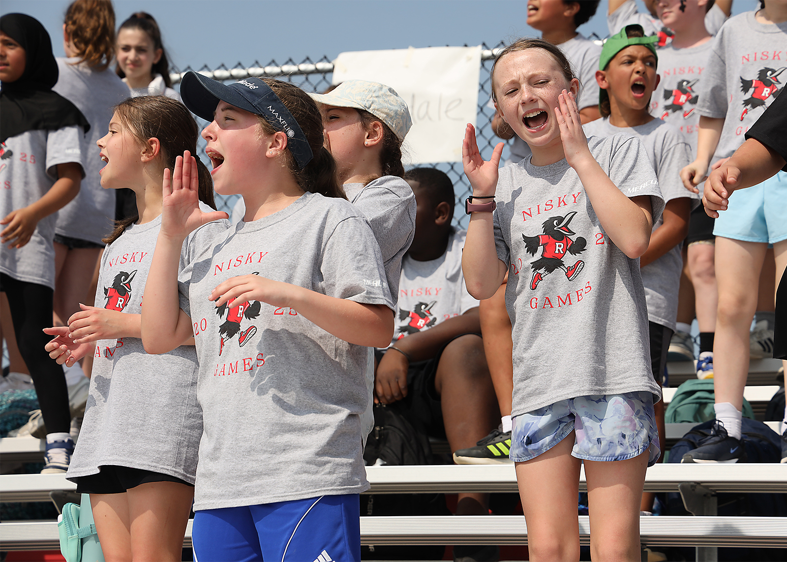 elementary students cheering in the bleechers