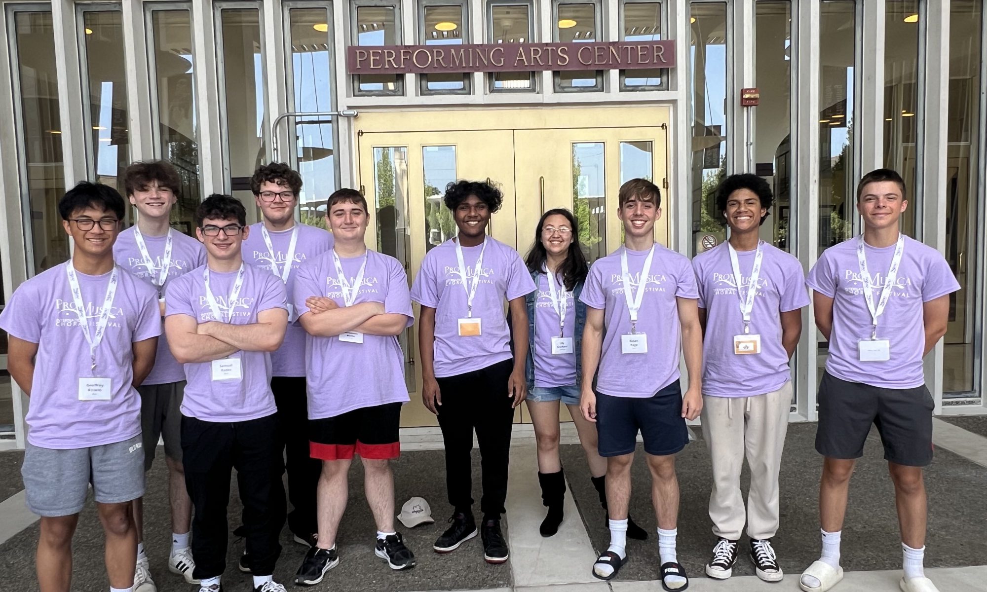 Ten Niskayuna music students standing outside in front of a performing arts center